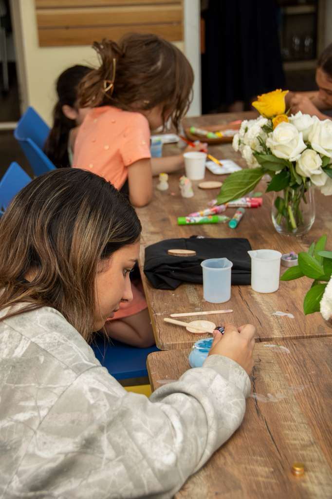A guest concentrating on mixing coloured wax