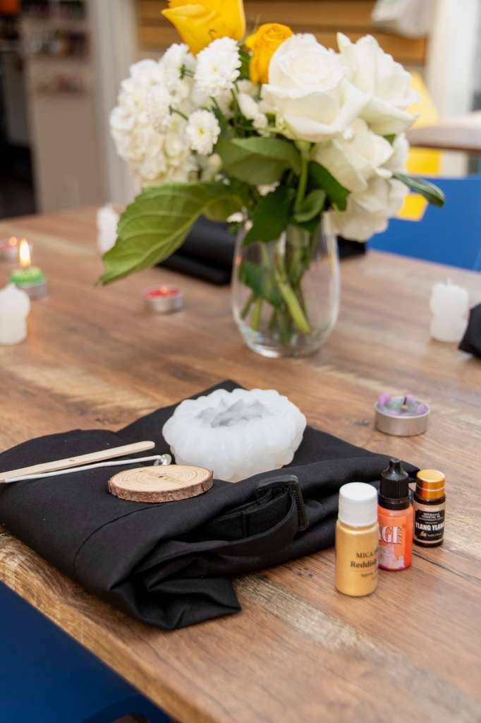 Apron, mould, wooden disc and oils laid out at a place setting